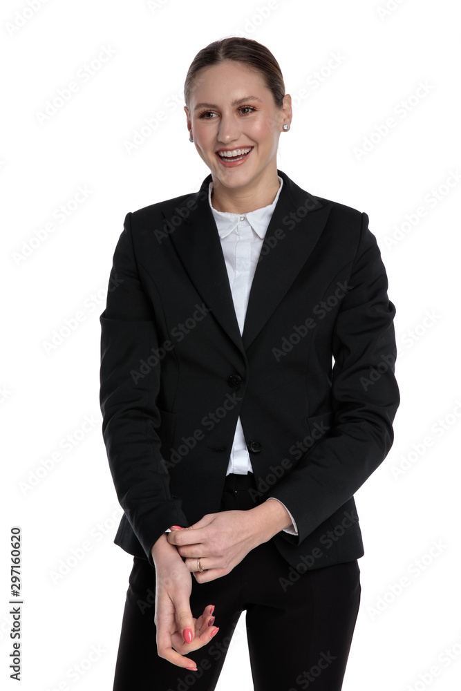 businesswoman standing and fixing sleeve with big smile businesswoman standing and fixing sleeve with big smile