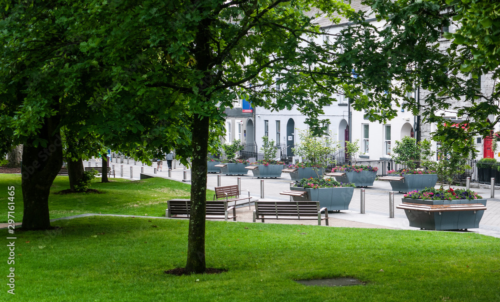 View of Eyre Square, Galway City on a quiet summer morning showing the surrounding flora and buildings