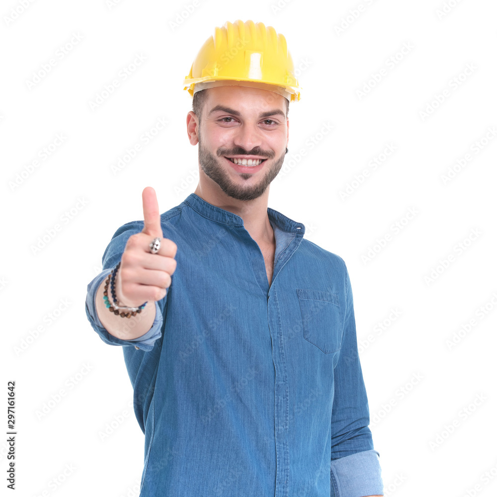 Positive casual man giving and thumbs up and smiling Positive casual man giving and thumbs up and smiling