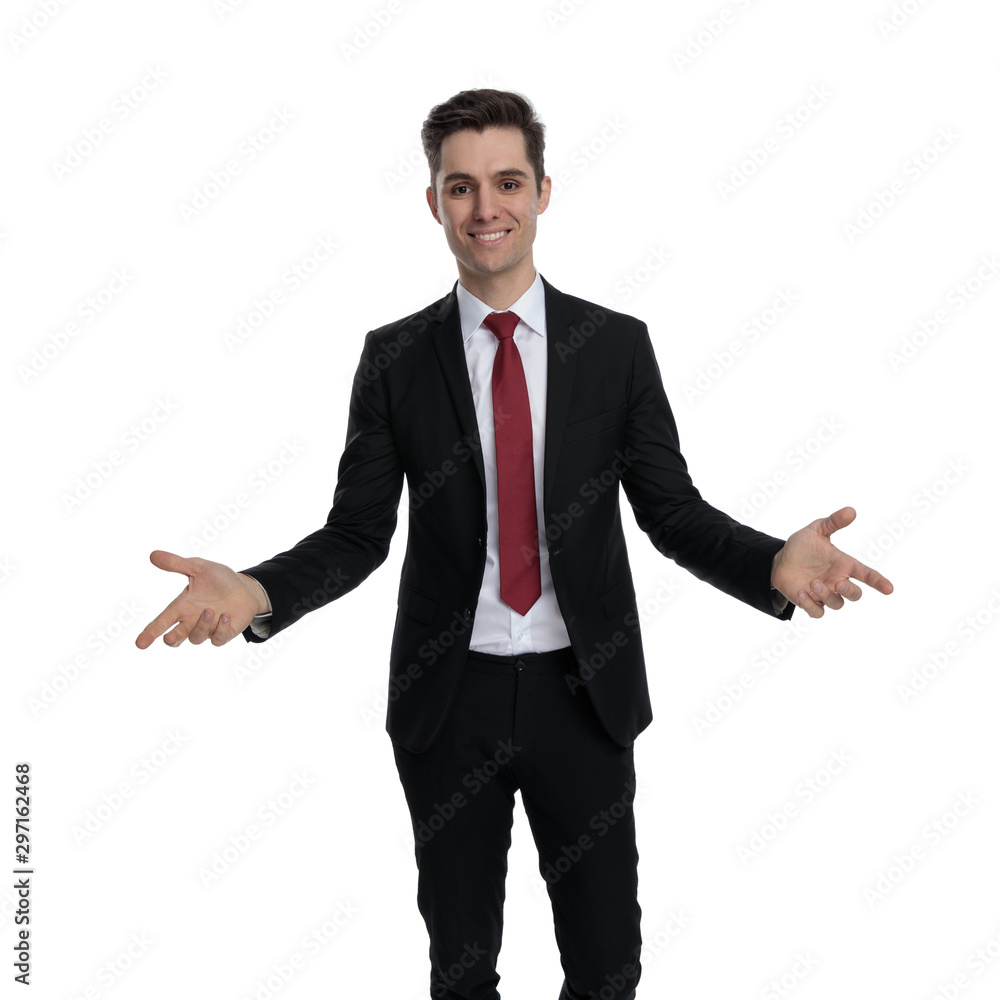 Positive young businessman welcoming and smiling Positive young businessman welcoming and smiling