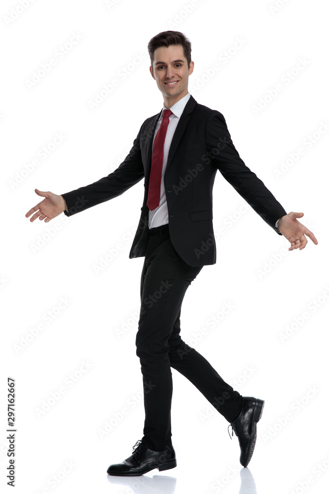 Side view of a cheerful businessman welcoming Side view of a cheerful businessman welcoming