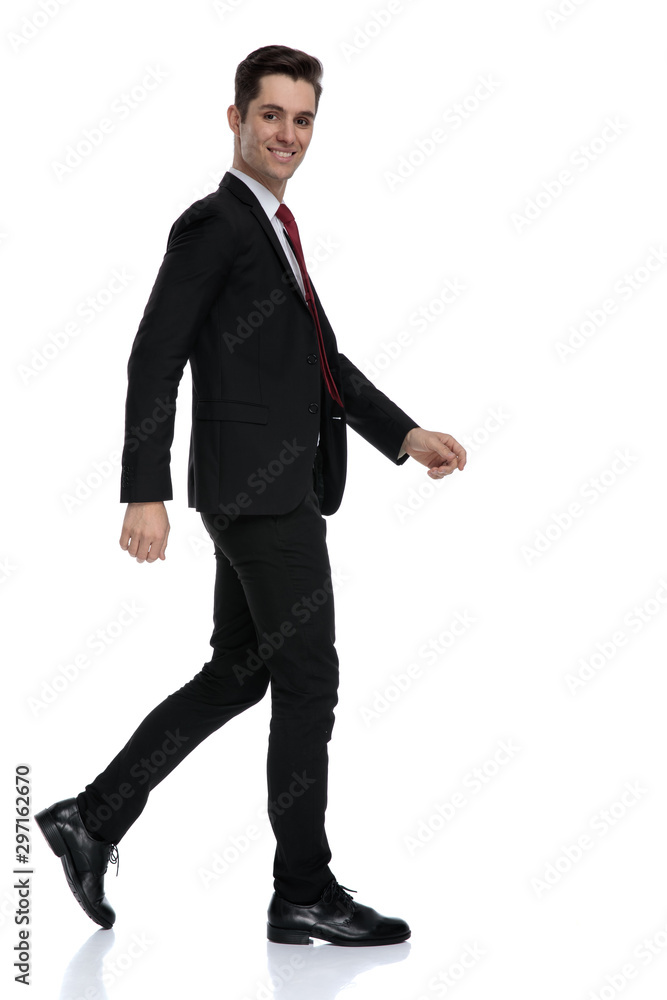 Side view of a cheerful businessman smiling while moving Side view of a cheerful businessman smiling while moving