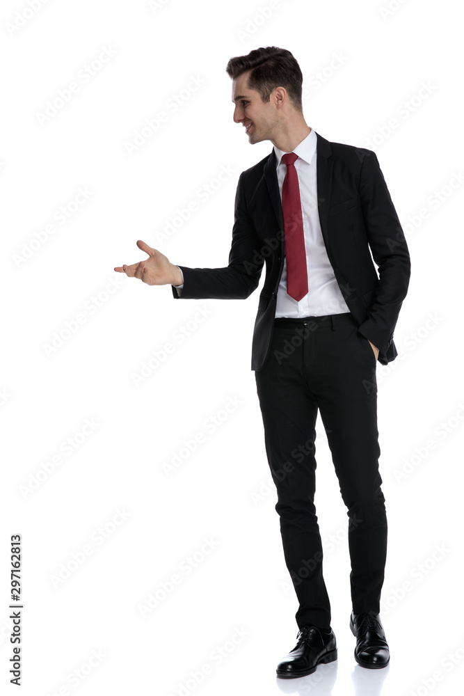 Cheerful businessman holding his hand in his pocket and explaining Cheerful businessman holding his hand in his pocket and explaining