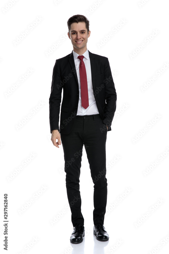 Cheerful businessman holding his hand in his pocket and smiling Cheerful businessman holding his hand in his pocket and smiling