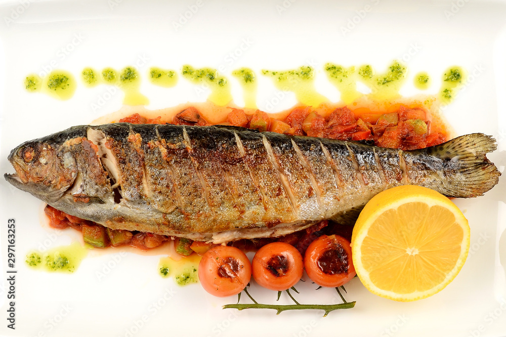 Fish with lemon and parsley on a plate Fish with lemon and parsley on a plate