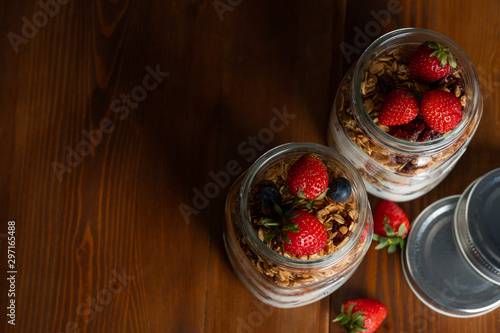 Healthy parfaits yoghurt with berries in mason glass jars