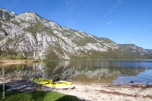 Kayak on the lake shore under a mountain