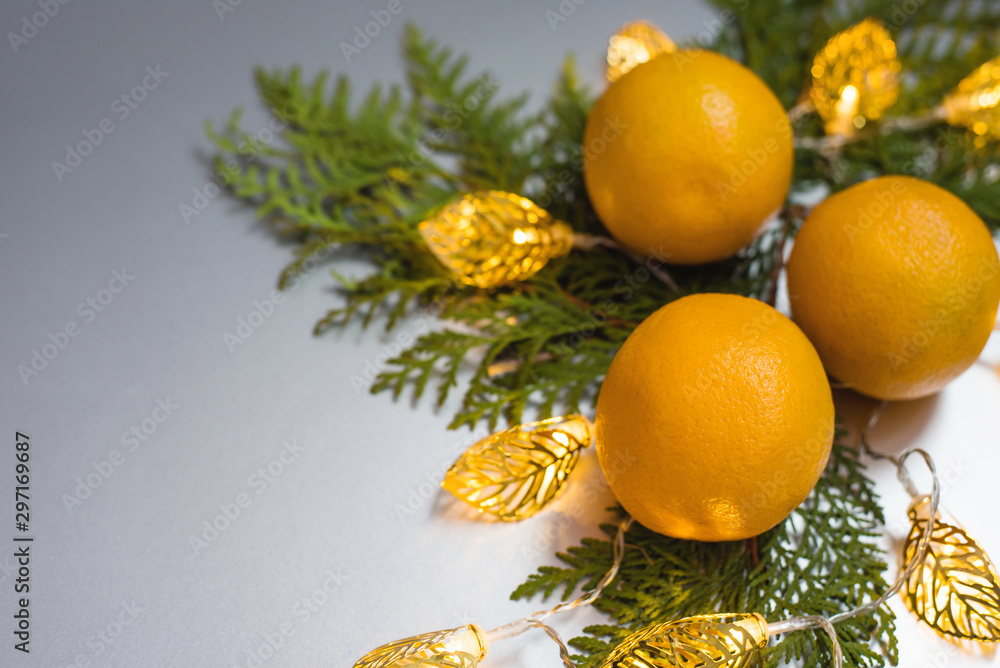 Christmas composition with fruits orange and garland on gray background Christmas composition with fruits orange and garland on gray background