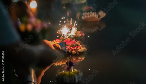 Photography Krathong floating on the river, Natural material made of Krathong, Loy Krathong festival , traditional Siamese new year festival celebrated annually throughout the Kingdom of Thailand