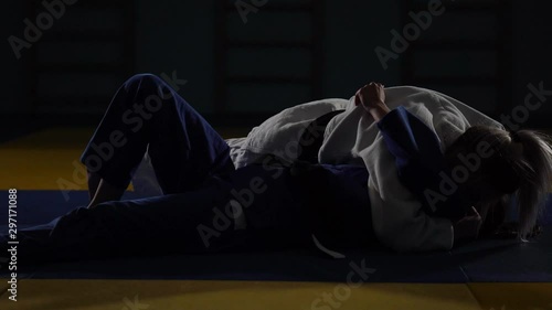 women are fighting on the tatami. judo