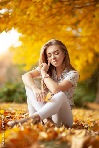 Beautiful woman enjoying in autumn forest