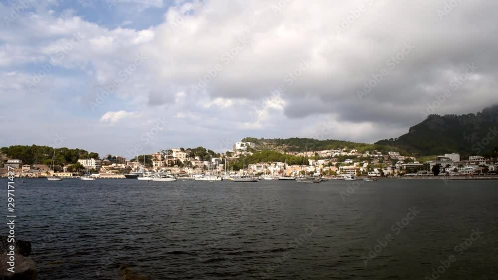 Port Soller Majorca view of the bay area from the boats moored in the harbour to the beautiful sandy beach and mountains in the background. Port Soller Majorca view of the bay area from the boats moored in the harbour to the beautiful sandy beach and mountains in the background.
