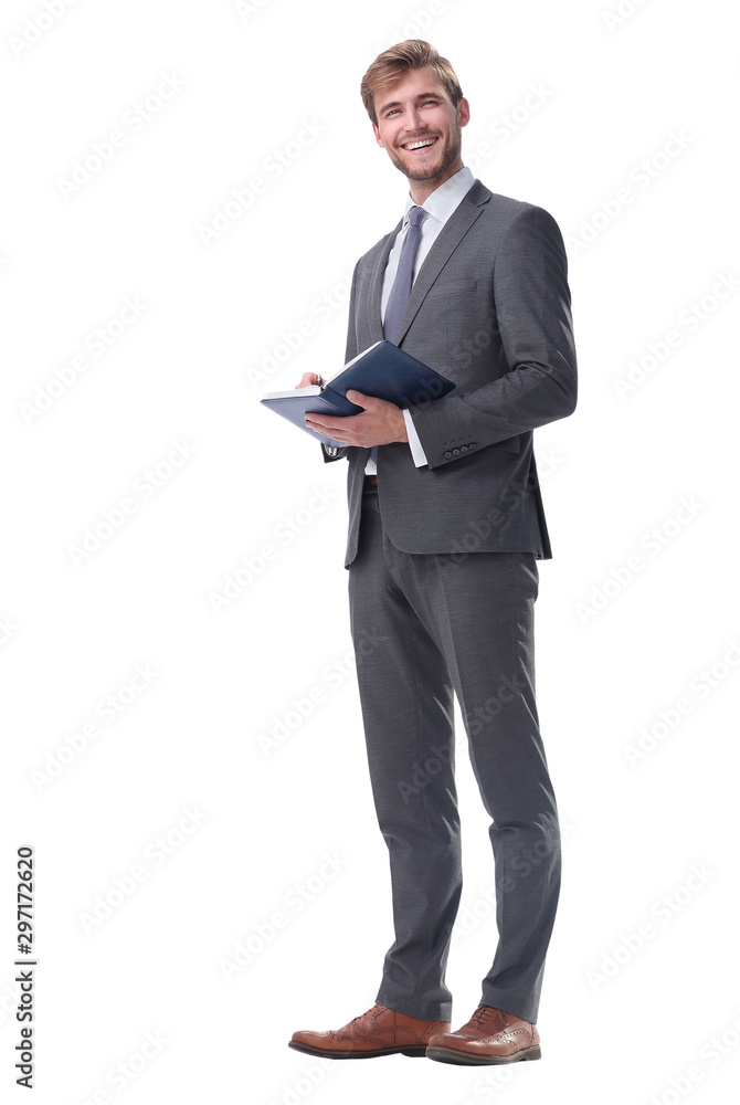 in full growth. successful businessman with a notebook. in full growth. successful businessman with a notebook.