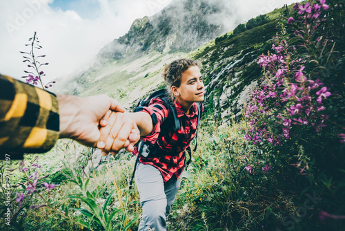 Follow me, girl holding boyfriends hands. The concept of the journey and new discoveries.