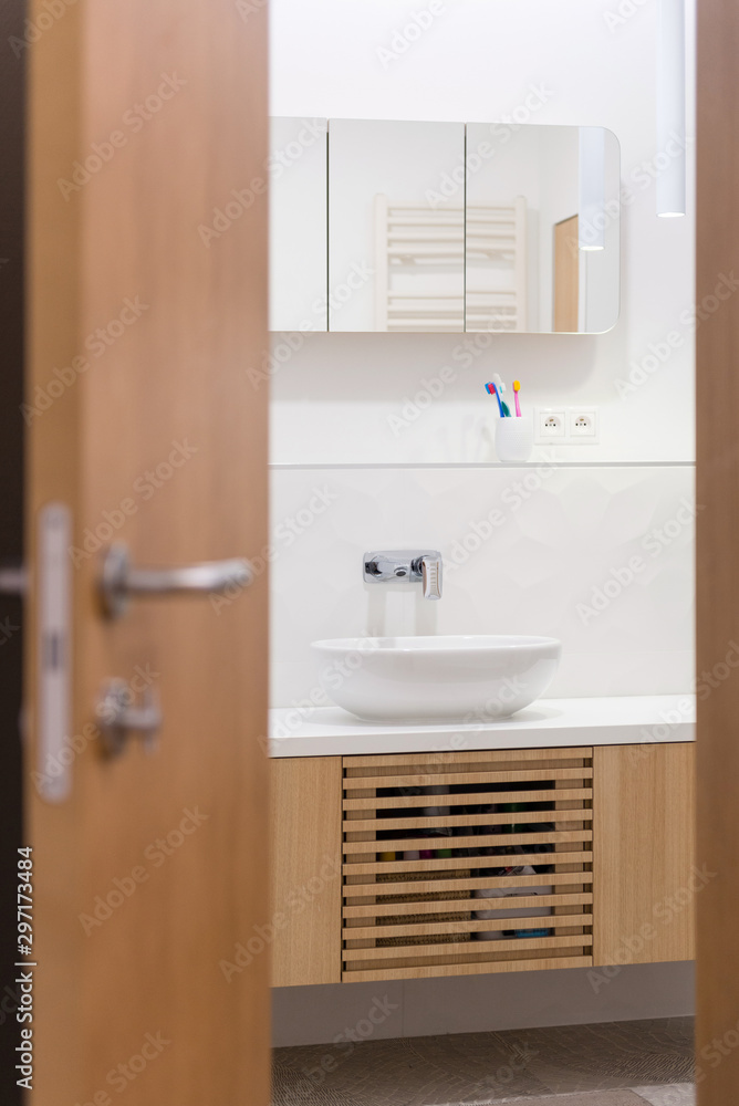 Obraz premium Interior of contemporary bathroom in white color with wood