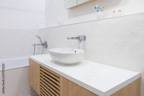 Interior of contemporary bathroom with bathtub and shower
