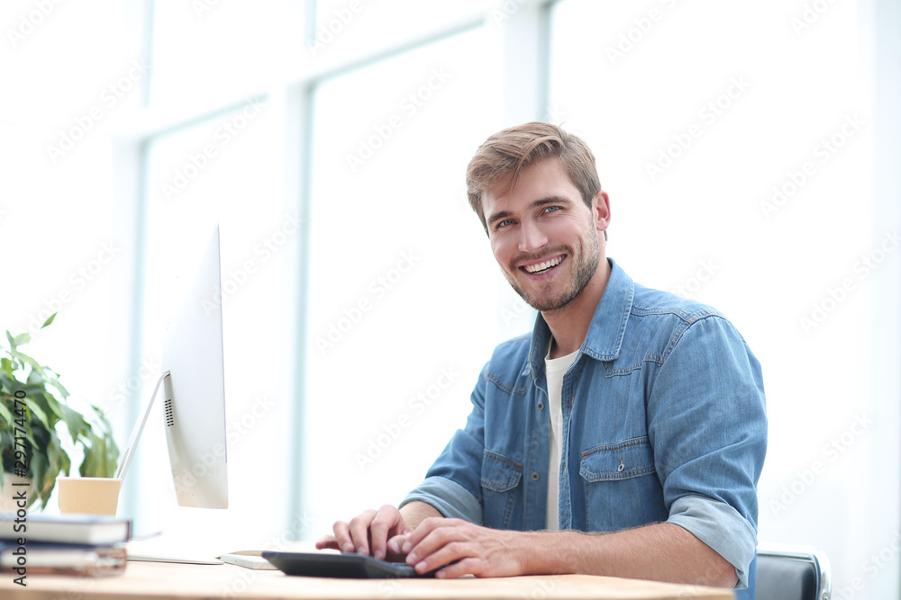 happy business man sitting at his Desk