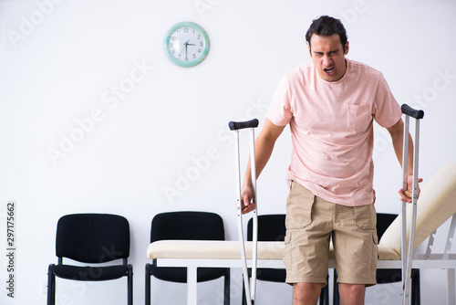 Young injured man waiting for his turn in hospital hall