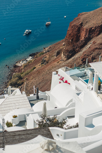 Greece, Santorini island, white houses and sea with yachts. Luxury background.