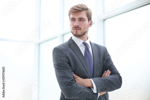 close up.serious young businessman standing in office.