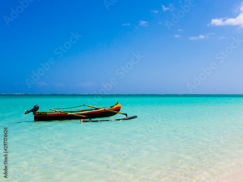 Colorful fishermen pirogue moored on turquoise sea of Nosy Ve island, Indian Ocean, Madagascar photo