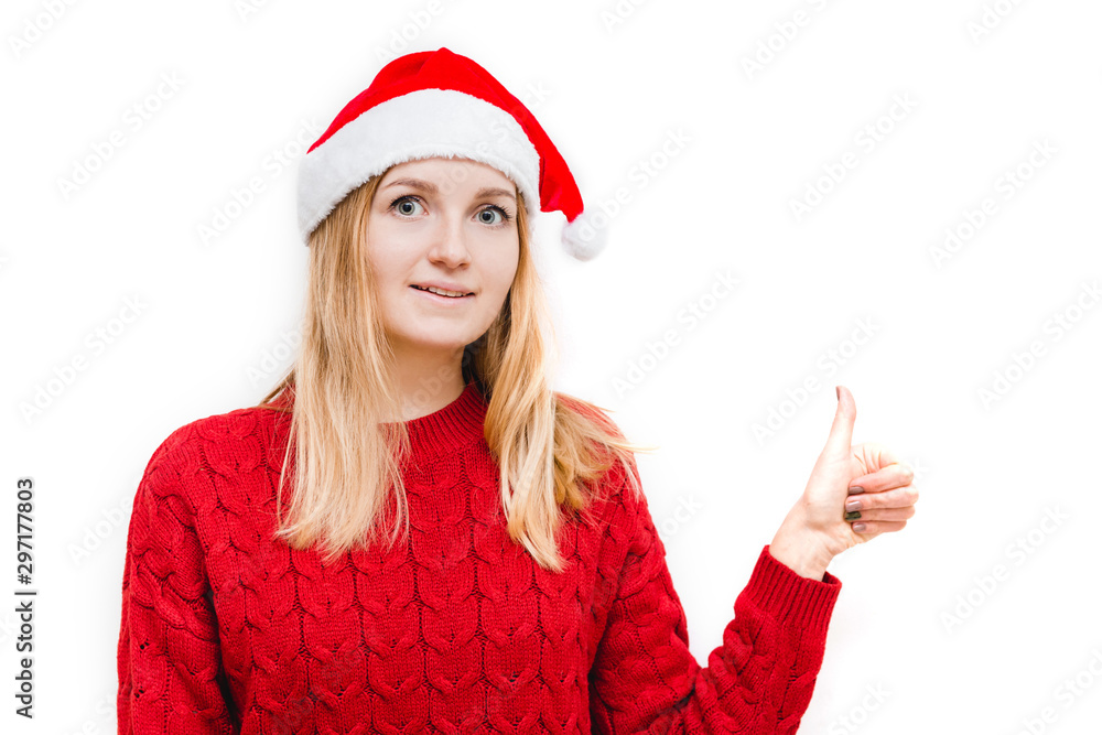 Cheerful woman in santa hat showing thumb up. Girl looking at camera and smiling isolated on white background. Cheerful woman in santa hat showing thumb up. Girl looking at camera and smiling isolated on white background.