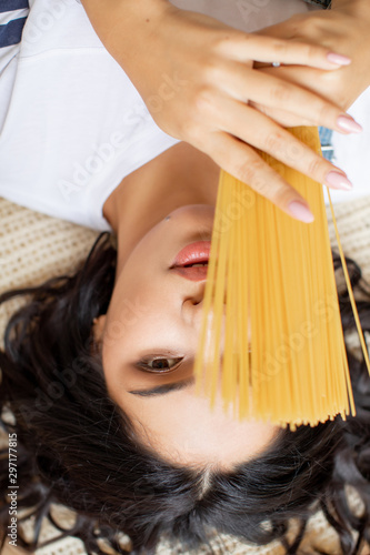 Girl in kitchen preparing vegetables and fruits in pajamas