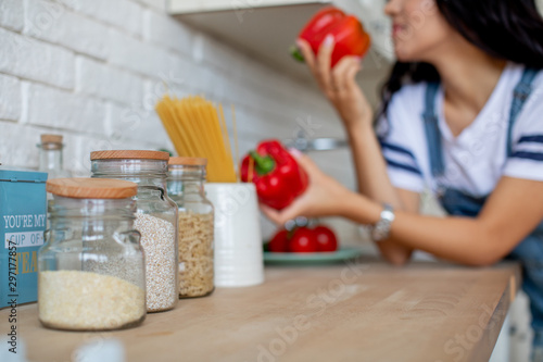 Girl in kitchen preparing vegetables and fruits in pajamas