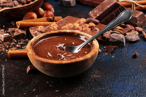 Chocolate bar pieces and melting swirl cocoa. Sweet food photo concept. The chunks of broken chocolate on table