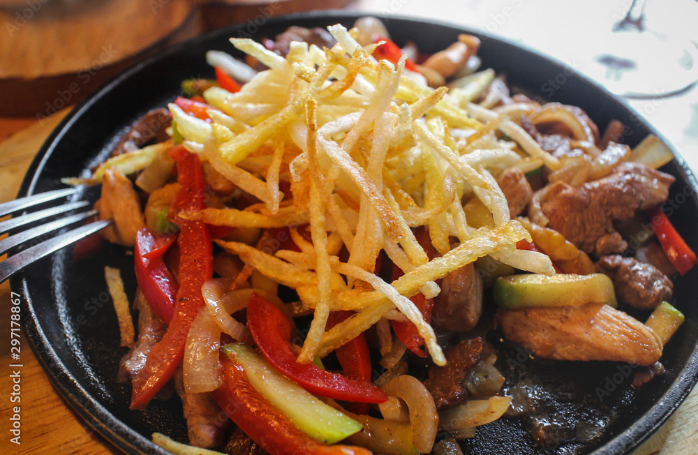 Meat roasted with vegetables and fried potatoes closeup, selective focus Meat roasted with vegetables and fried potatoes closeup, selective focus