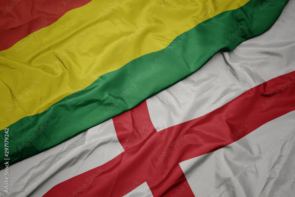 waving colorful flag of england and national flag of bolivia.