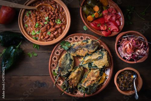 Canvas Print Chilles rellenos served in traditional mexican dishes, served with beans, pickle