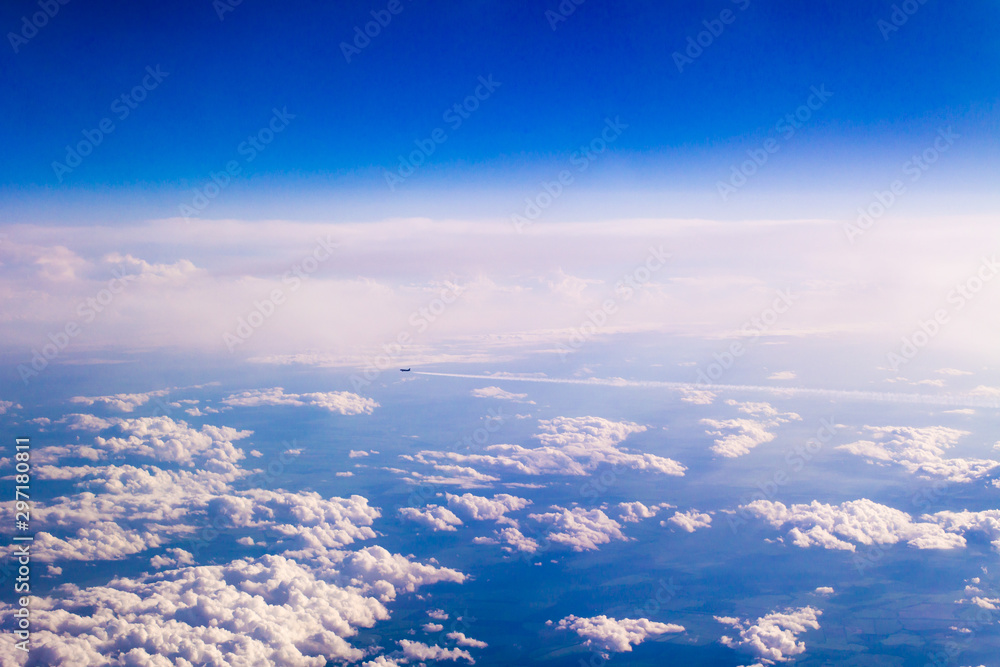 Aircraft flying away high above the clouds Aircraft flying away high above the clouds