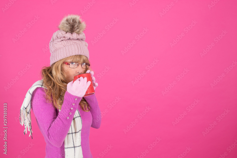 warm woman drinking with cup on color background warm woman drinking with cup on color background