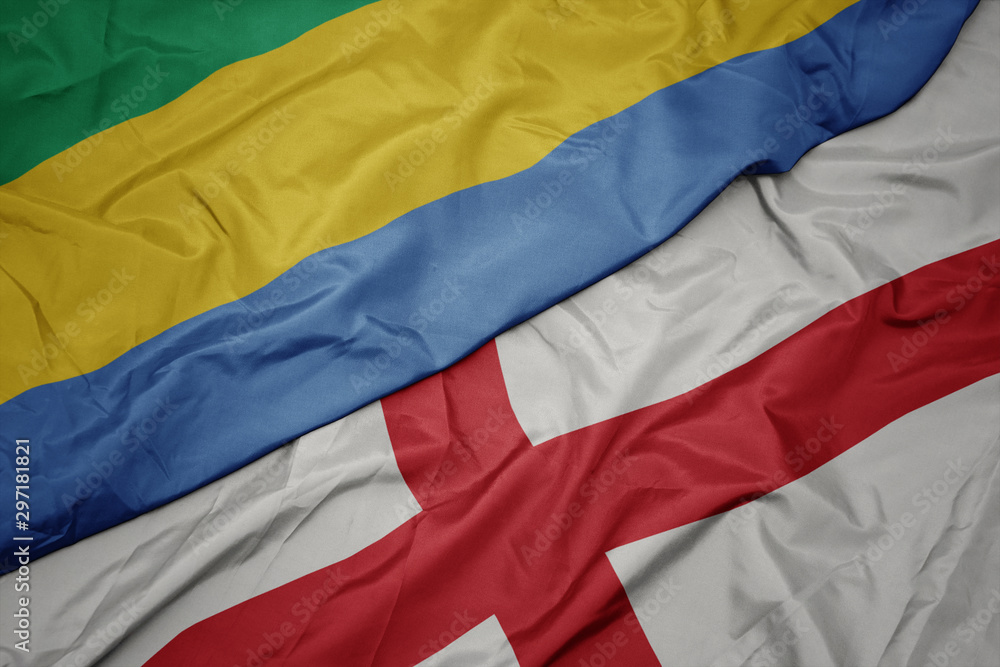 waving colorful flag of england and national flag of gabon.