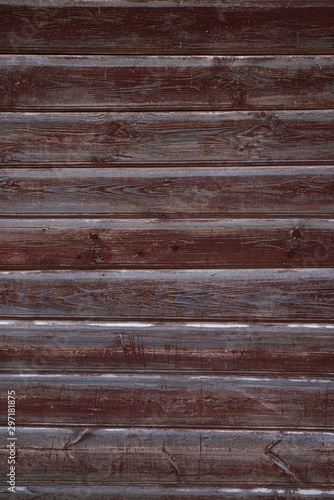 The texture of the old wall of wooden boards painted in Burgundy