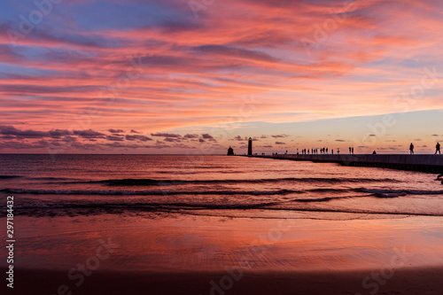 red sunset clouds on beach with pier