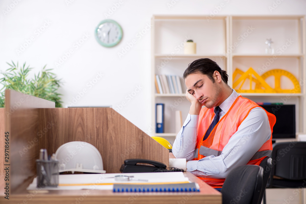 Young male architect working in the office Young male architect working in the office