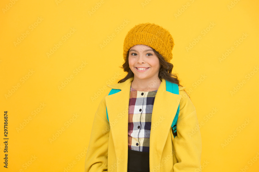 Happy childhood. Happy little girl on yellow background. Small child smile in autumn fashion. School time. Education that makes child happy. School and daycare Happy childhood. Happy little girl on yellow background. Small child smile in autumn fashion. School time. Education that makes child happy. School and daycare