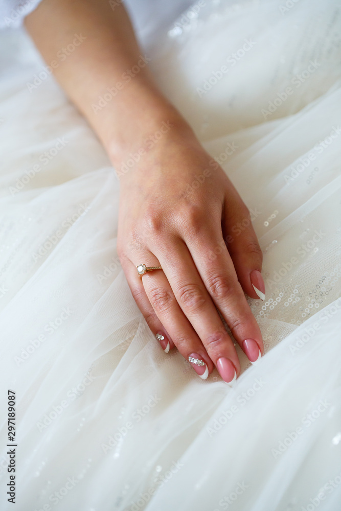 the bride holds in her hands a beautiful wedding dress the bride holds in her hands a beautiful wedding dress