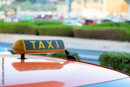 Taxi car is waiting for a passenger on the street in Dubai, United Arab Emirates.