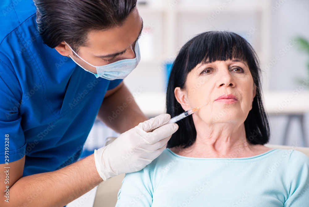 Old woman visiting male doctor for plastic surgery Old woman visiting male doctor for plastic surgery
