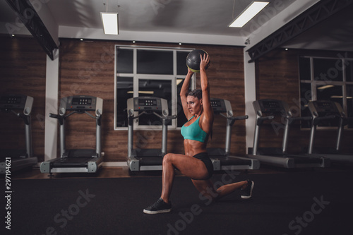 Fit girl in the gym with medicine ball