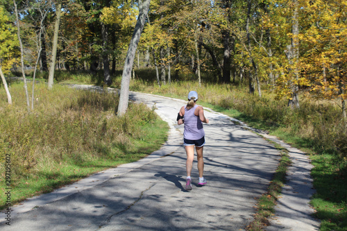 Woman running on the North Branch Trail at Miami Woods in autumn