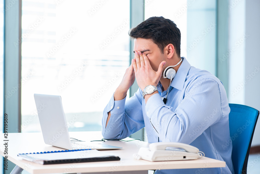 Male call-center operator in business concept Male call-center operator in business concept