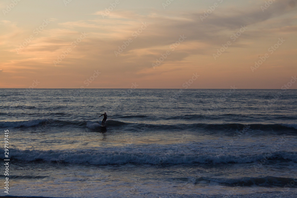 Surfer on the Beach at Sunset Surfer on the Beach at Sunset