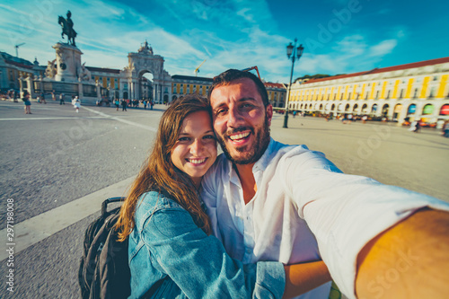 happy tourist traveling in Lisbon, taking selfie photo in the most important site of Lisbon, capital of Portugal