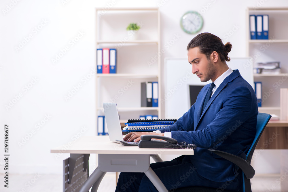 Young male businessman working in the office Young male businessman working in the office