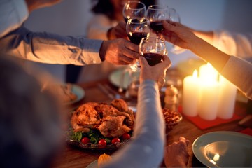 Family and friends dining at home celebrating christmas eve with traditional food and decoration, all sitting on the table together
