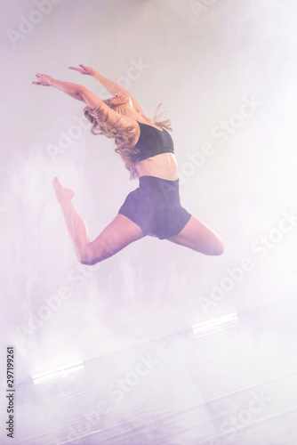 Young modern dancer dancing in the studio. Sport, dancing and urban culture concept. Group of young dancers performing on the stage. Effective performance. beautiful dance. full of energe dancers.